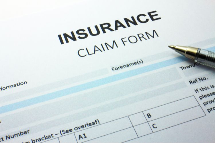 A Blank Insurance Claim Form With a Pen Resting on Top of It