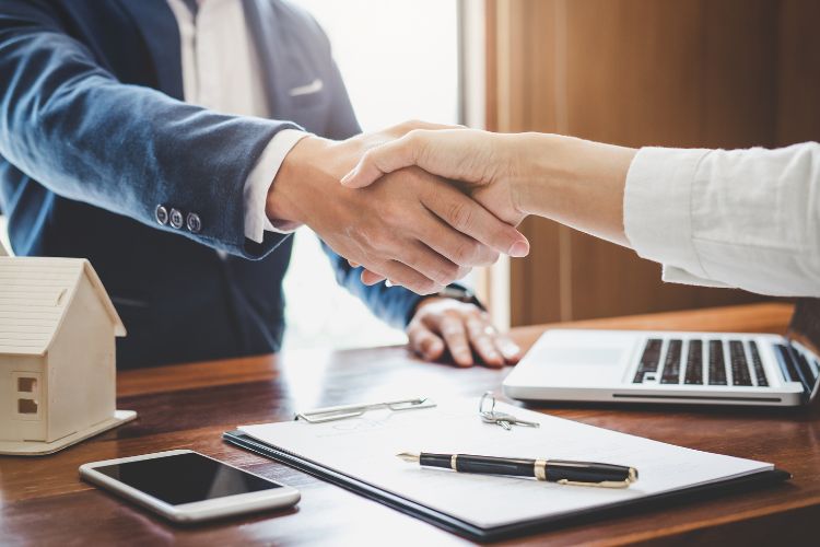 Building Insurance Agent Shaking Hands With Customer