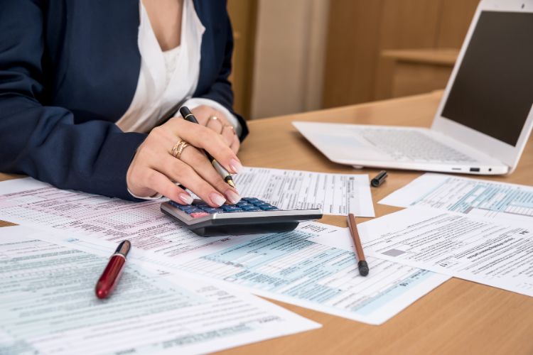 Woman Reporting Income and Filling Tax Forms